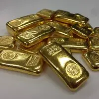Altın külçeleri ve finansal grafikler