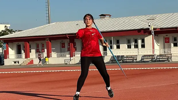 Meryem Hanne Erbil, kazandığı madalyalarla birlikte atletizm pistinde.