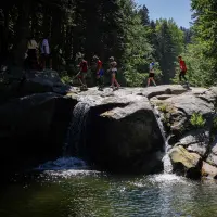 Uludağ Ultra Trail'de koşan sporcular ve Bursa'nın doğal güzellikleri.