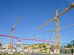Baustelle für neue Wohnhäuser in Berlin mit Baukranen und Rohbauten