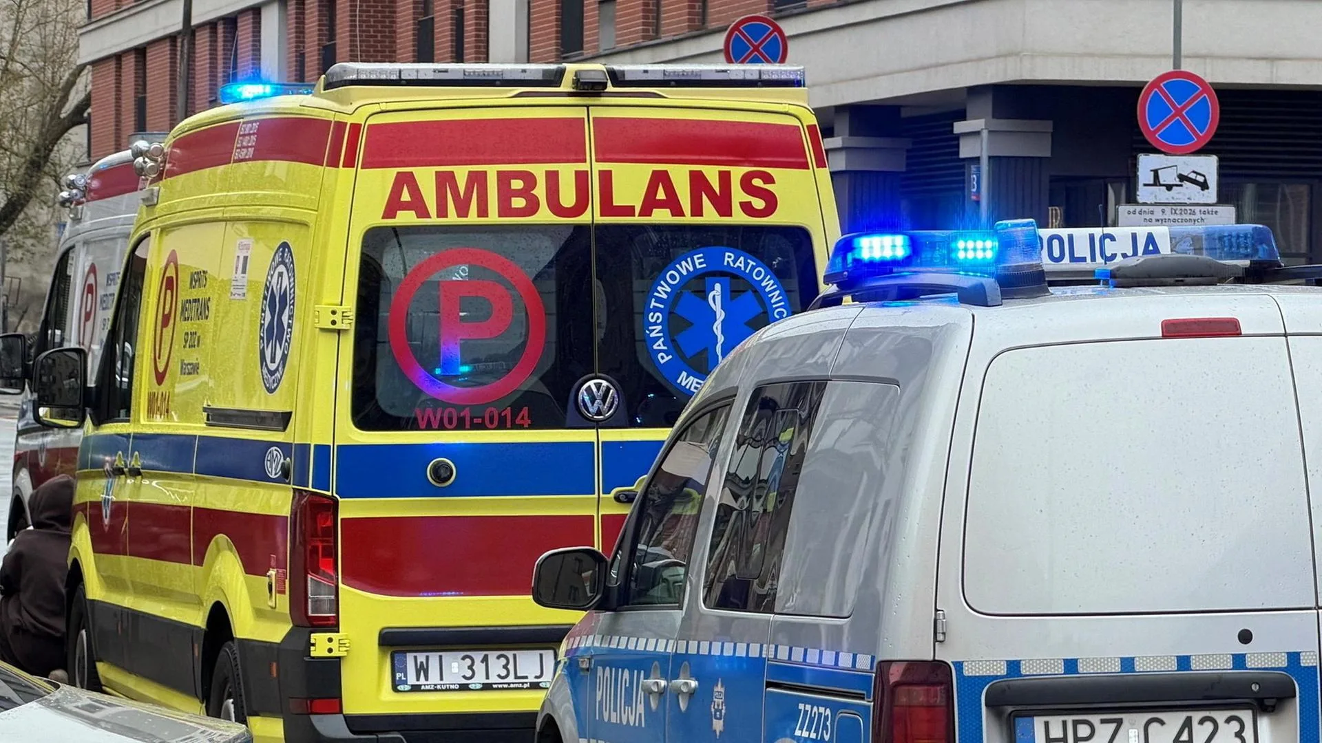 Polizeifahrzeuge vor einem Schulgebäude in Warschau nach Sicherheitsmaßnahmen.