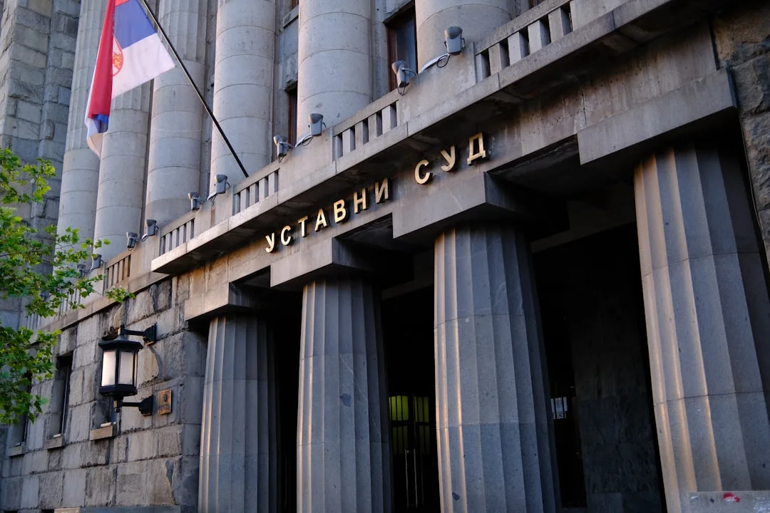 Serbian Parliament building with protesters in the foreground, symbolizing political tension.